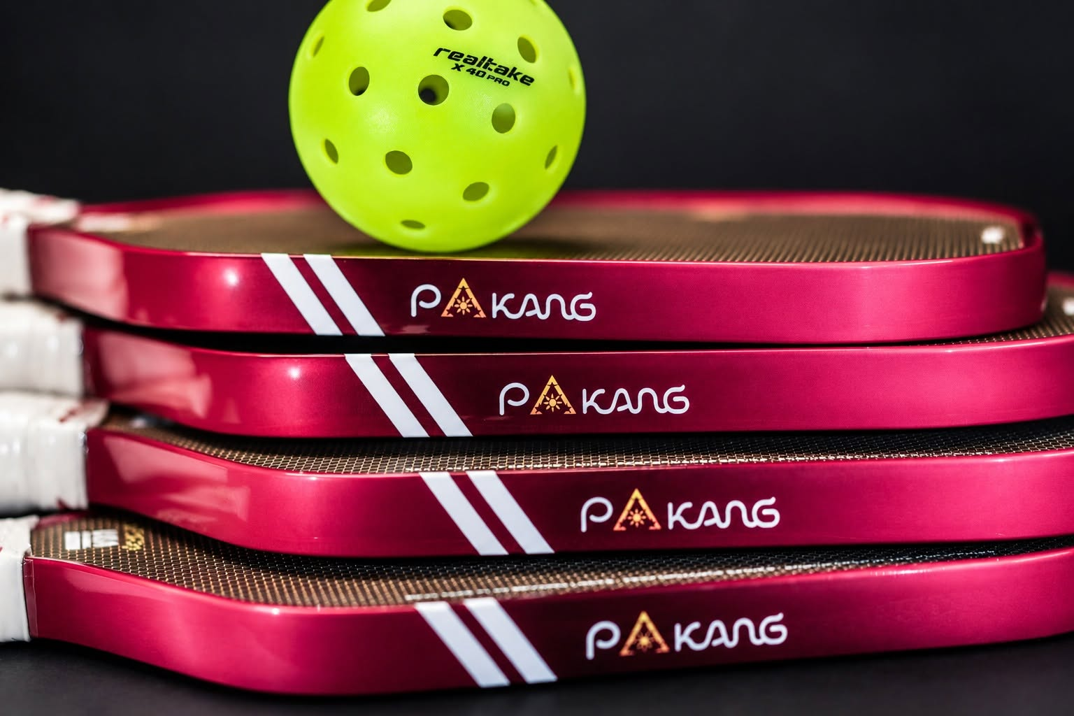 Stack of PAKANG pickleball paddles with the RealTake X40 Pro ball